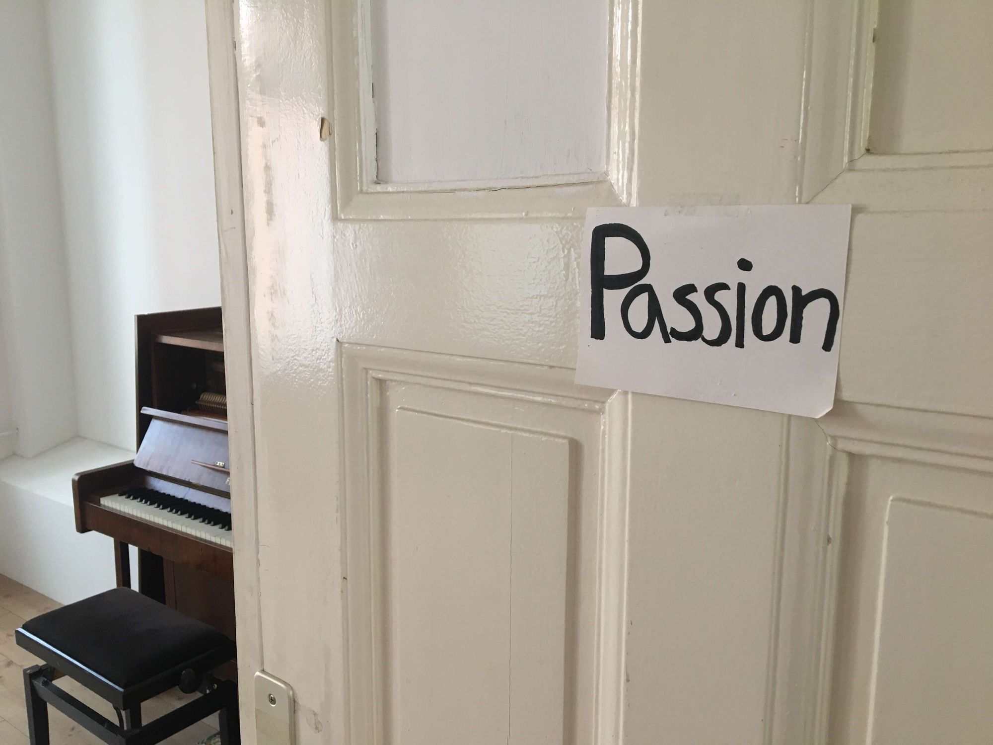 a door reading with a sign saying "passion"